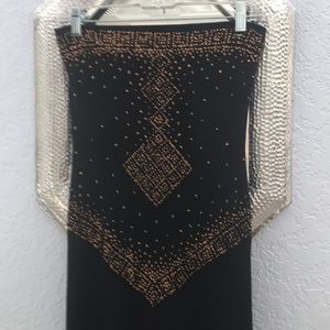 Long, black, strapless dress with gold detail